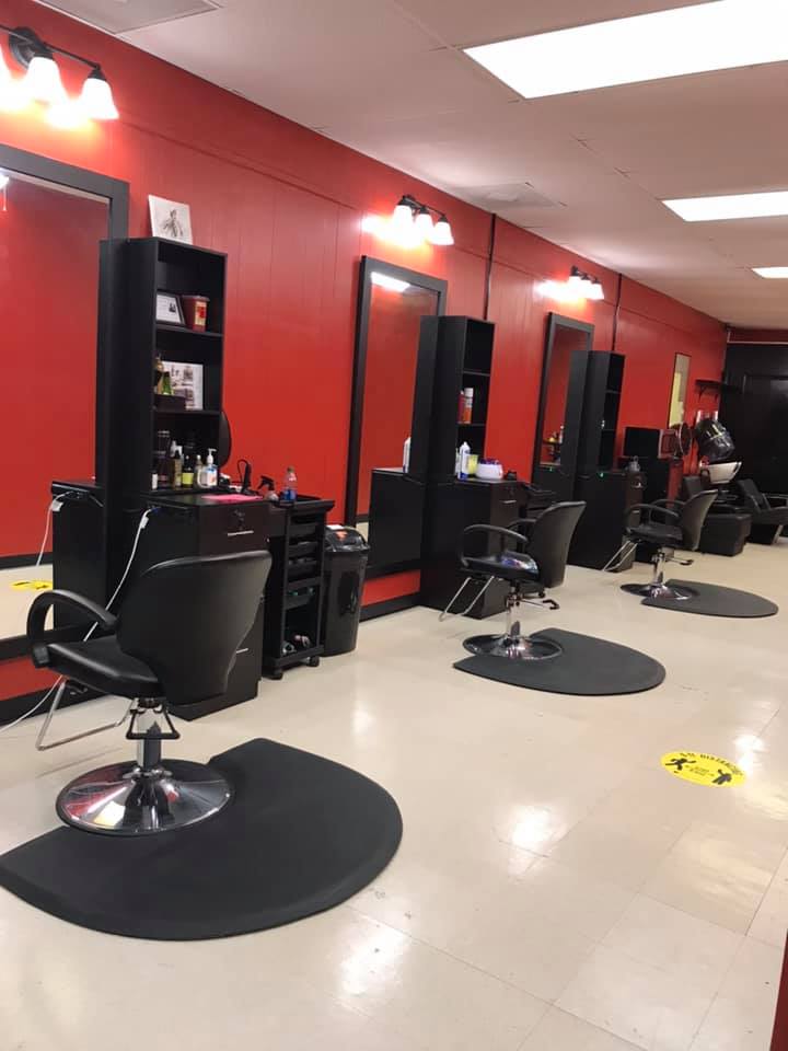 Inside the salon, styling chairs against red walls